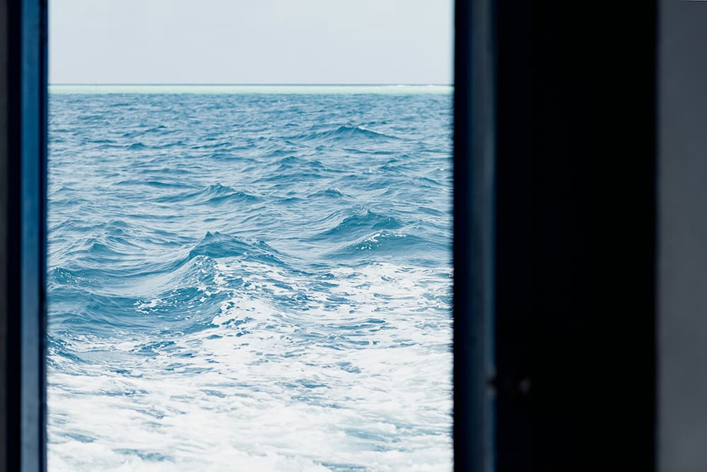 View of the sea with large waves from ship window