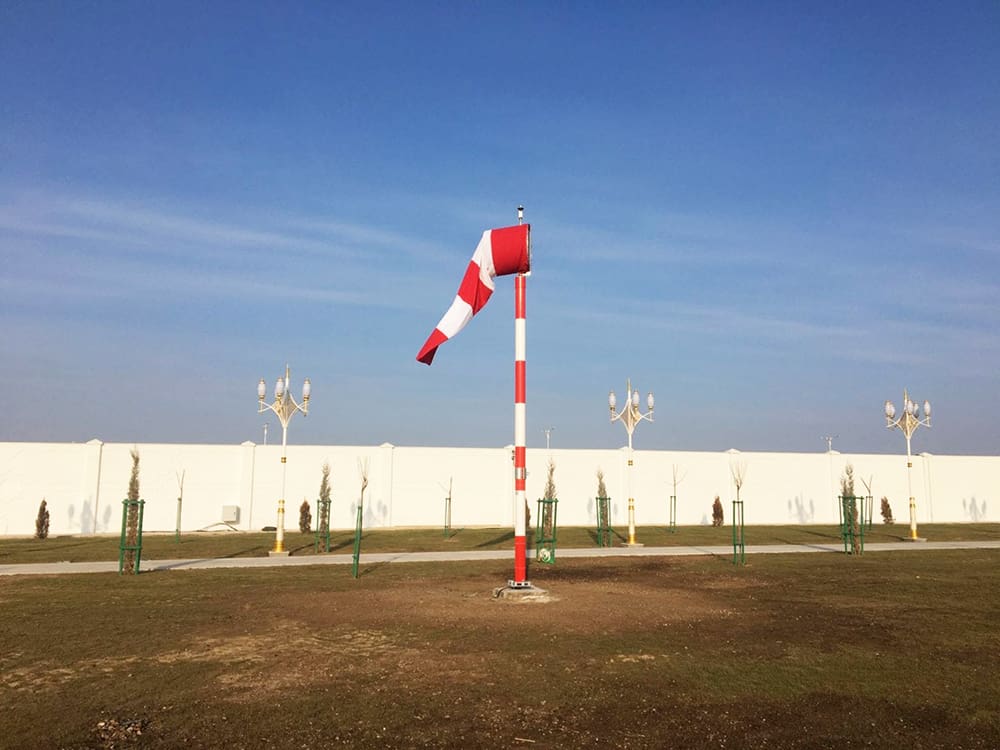 Red and white windsock and frangible mast at airfield in Turkmenistan